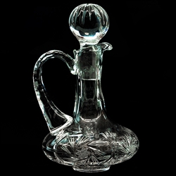 Handsome Polish lead crystal cruet hand cut with a starburst design.