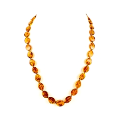 The beads on this beautiful necklace are a unique shape and knotted between each bead.  As you can see from the photographs they are a stunning honey color.