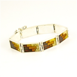 Hinged sterling silver cuff bracelet consists of 8 rectangular segments, inlaid with multi-color mosaic amber. The process to create this amber mosaic is quite unique.  See the video below.