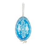 This beautifully designed egg is dyed one color, then white wax is melted and applied to form an intricate design which is left on the surfce. The egg is emptied and strung with ribbon for hanging.