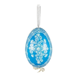 This beautifully designed egg is dyed one color, then white wax is melted and applied to form an intricate design which is left on the surfce. The egg is emptied and strung with ribbon for hanging.