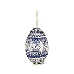 This beautifully designed egg is dyed one color, then white wax is melted and applied to form an intricate design which is left on the surfce. The egg is emptied and strung with ribbon for hanging.