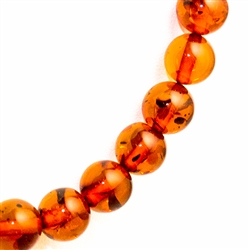 Delicate round multi-colored amber beads about .75cm in diameter. form this beautiful necklace.