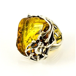 This is an adjustable amber ring. Fits a size 9 comfortably as is but can be expanded or contracted to fit larger or smaller size fingers.
Features a triangular shaped large clear honey amber cabochon.