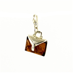 Very precious looking honey amber purse charm set in sterling silver.