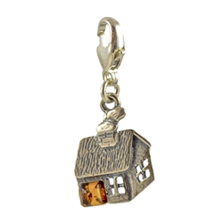 Very precious looking honey amber house charm in sterling silver.