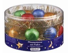 Made In Germany these round tinsel stars are made to hang on the Christmas tree.   Each center is made up of two round milk chocolate tabs covered in colorful foil.  Careful not to hang them close to lights as they will melt.  Approximately 3" (7cm) in di