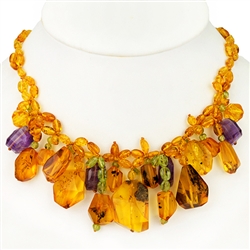 Bozena Przytocka is a designer of artistic amber jewelry based in Gdansk, Poland. Here is a beautiful example of her ability to blend amber, amethyst and peridot to create a stunning necklace.