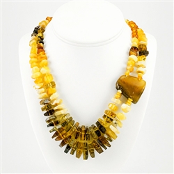 Bozena Przytocka is a designer of artistic amber jewelry based in Gdansk, Poland. Here is a beautiful example of her ability to blend multiple shades of amber to create a stunning necklace Knotted between each bead.