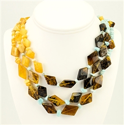 Bozena Przytocka is a designer of artistic amber jewelry based in Gdansk, Poland.   Here is a beautiful example of her ability to blend multiple shades of amber and larimar to create a stunning necklace.