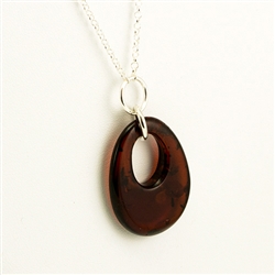 This beautiful oval of amber hangs on a long 34" sterling silver chain.