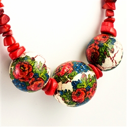 Beautiful folk necklace made with natural looking coral like beads and decoupaged wooden beads featuring folk flowers.  Adjustable metal clasp.  Maximum length 25" - 64cm.  Made In Zakopane, Poland.