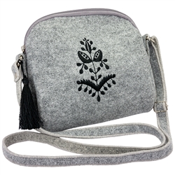 A little, smart handbag made of felt. The center decoration is vivid embroidery inspired by Belarusian folklore. (made by Farbotka brand). Ideal for casual events. Quilted lining inside. One zippered compartment. Adjustable leather strap. Finished with a