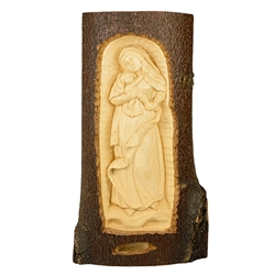 The Madonna And Child are carved in the side of a tree slab.  Very nice detail.