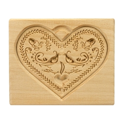 Solid beech wood hand carved mold featuring a traditional heart shape folk design.  This mold comes from the gingerbread museum in Torun, Poland.  These types of wooden molds are used to create gingerbread and cookie designs.