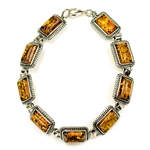 9 rectangular shaped amber beads each set in a sterling silver frame. 7" - 18cm long.