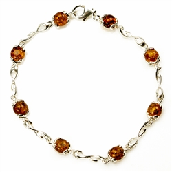 8 round amber beads each set in a sterling silver frame. 7.5" - 19cm long.