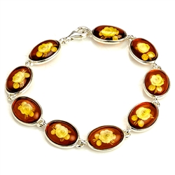 9 beautiful oval amber cameo beads (carved roses) each set in a sterling silver frame. 7" - 18cm long.