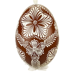 This beautifully designed egg is dyed one color, then white wax is melted and applied to form an intricate design which is left on the surfce. The egg is emptied and strung with ribbon for hanging or you can remove the ribbon. This is the work of maste