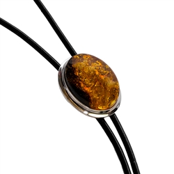 Beautiful black bolo tie with a large centerpiece of cognac amber set in a sterling silver casing.  Silver tipped ends.