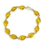 10  tear drop shaped amber beads each set in a sterling silver frame. 7" - 18cm long.