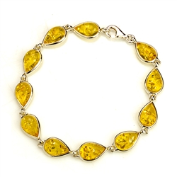 10  tear drop shaped amber beads each set in a sterling silver frame. 7" - 18cm long.