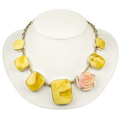 This beautiful set is composed of custard Baltic amber and rare Mediterranean hand carved pink conch (strombus).