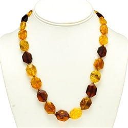 This stylish amber necklace features shades of yellow, honey, and cherry amber. The beads are slightly hexagonal in shape and slightly faceted.