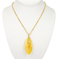 Beautiful custard amber cabochon suspended on a 14k finding.  18" long 14k gold filled chain.