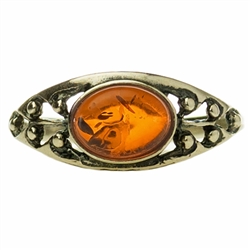 A small oval of honey amber set in a classic sterling silver setting. Size approx .25" x .4"