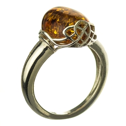 A beautiful oval amber cabochon set in sterling silver with a Celtic design.