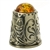 A beautifully designed silver thimble topped with amber.  Size approx 1" x .75".