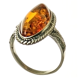 A beautiful oval of cognac colored amber set in sterling silver.   Size approx .75" x .5".