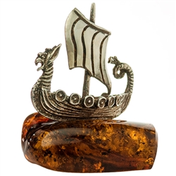Our little sterling silver Viking ship is traveling on a sea of amber.  Nicely detailed. Approx size 1.5" x 1.25" x 1.75".