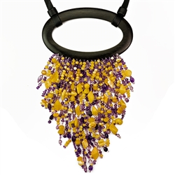 Bozena Przytocka is a designer of artistic amber jewelry based in Gdansk, Poland. Here is a beautiful example of her ability to blend amber and amethyst to create a stunning necklace. The straps are leather and the  centerpiece is ebony.  The longest bead
