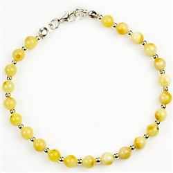 Circular custard amber and silver beads with sterling silver claw clasp.