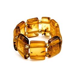 Delightful slices of natural amber connected by a double strand of of woven stretch material and separated with beads. Rings start at size 5 and stretch to fit the largest fingers. Amber size varies from .3 to .4" high.