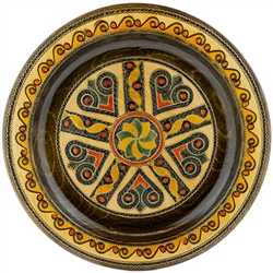 This Polish plate is made from beech wood in the mountain region of southern Poland called Podhale.  The plates are cut and shaped on a lathe by hand.  The floral designs are burned into the wood then painted after staining and varnishing.  All the flower