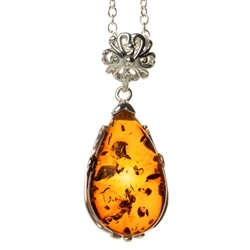 Beautiful sterling silver pendant and adjustable length chain.  Sterling silver filigree like frame around this beautiful piece of amber.