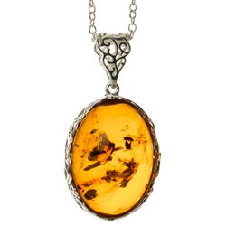 Beautiful sterling silver pendant and adjustable length chain, framing a large oval shaped amber cabochon.