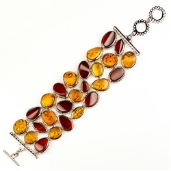 Interlocking amber cabochons each framed in silver to form a stunning 8" long bracelet. Matching necklace available - see product code 9824028.