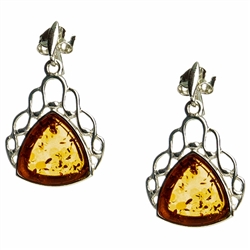 Artistic antique oval shaped silver earrings with a center of honey colored amber. Approx 1" long.