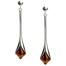 Drops of honey amber wrapped in silver in a calla lily shape.  Stylish and unique.