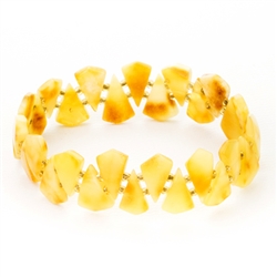Custard amber slices with beads between each piece.  Size approx 2.25" diameter before stretch.  Approx .75" wide.  Shades of amber will vary from bracelet to bracelet.