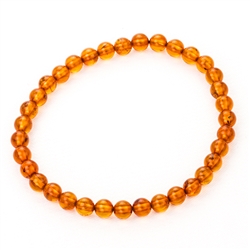 Beautiful round cognac amber beads on elastic band. Size approx 2.25" diameter.  Bead size approx 4mm.