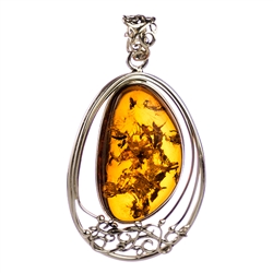Sterling Silver with filigree detail surrounding a beautiful honey amber cabochon.