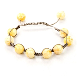 This fine macrame bracelet is made with 10 custard colored amber spheres. This bracelet includes grey cord and a slide clasp to fit most wrists.
