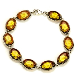 10 beautiful oval amber cameo beads (carved roses) each set in a sterling silver frame. 7" - 18cm long.