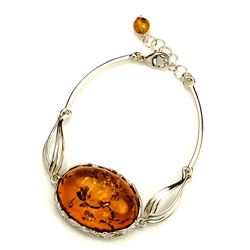 This sterling silver bracelet features a gorgeous center of honey amber.