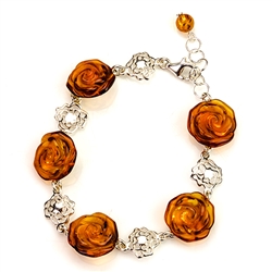 5 hand carved amber roses each set on a filigree sterling silver circle. Adjustable from 7" - 8" long.